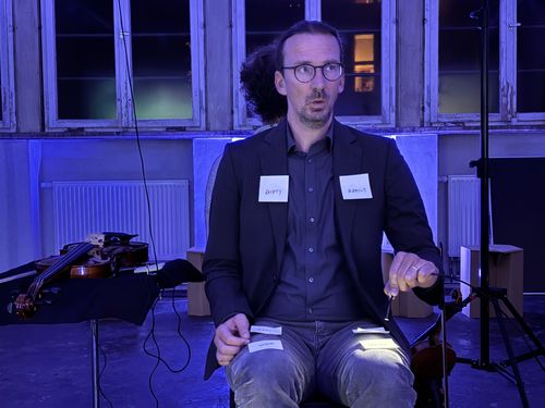 man sitting on a chair during the performance of 