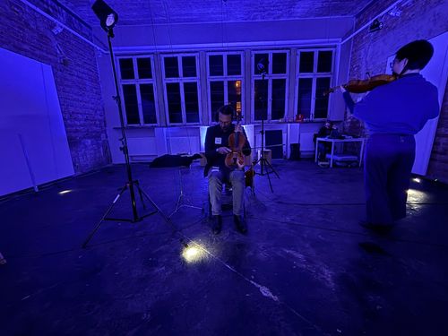 two string players at the performance of “Abstract Pieces 2” by Manos Tsangaris Tsangaris