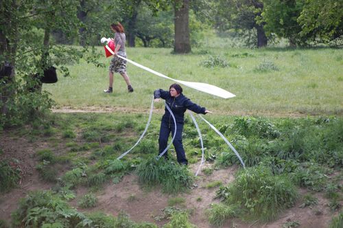 photo showing a moment from the piece “Schwalbe”, which was performed on and by a small river
