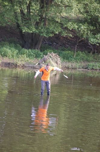 photo showing a moment from the piece “Schwalbe”, which was performed on and by a small river