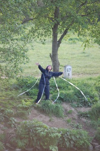 photo showing a moment from the piece “Schwalbe”, which was performed on and by a small river