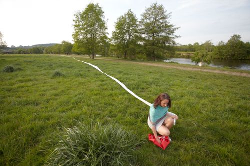 photo showing a moment from the piece “Schwalbe”, which was performed on and by a small river