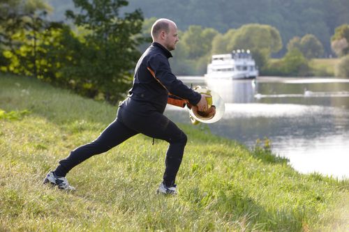 photo showing a moment from the piece “Schwalbe”, which was performed on and by a small river